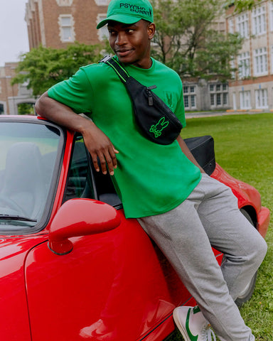 A man leaning against a red car wearing retractableawningsale